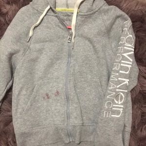 Calvin Klein zip up with tiny red lipstick stain